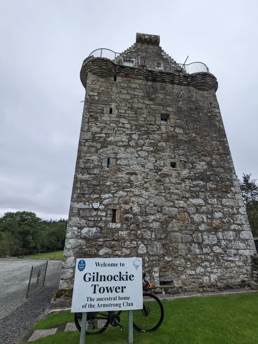 A tall weathered stone tower viewed from below