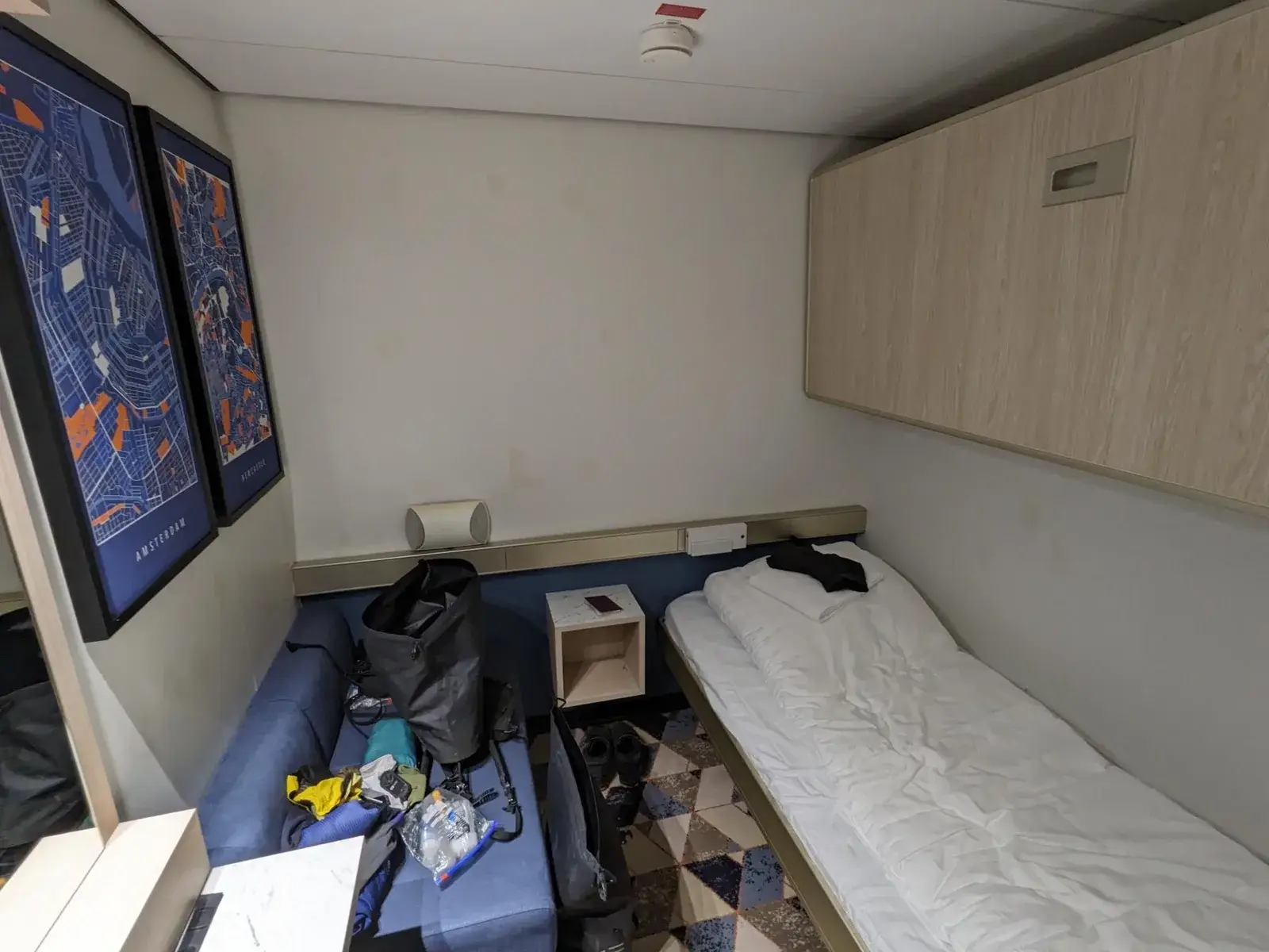 A simple cabin with cycling kit laid out on the bed