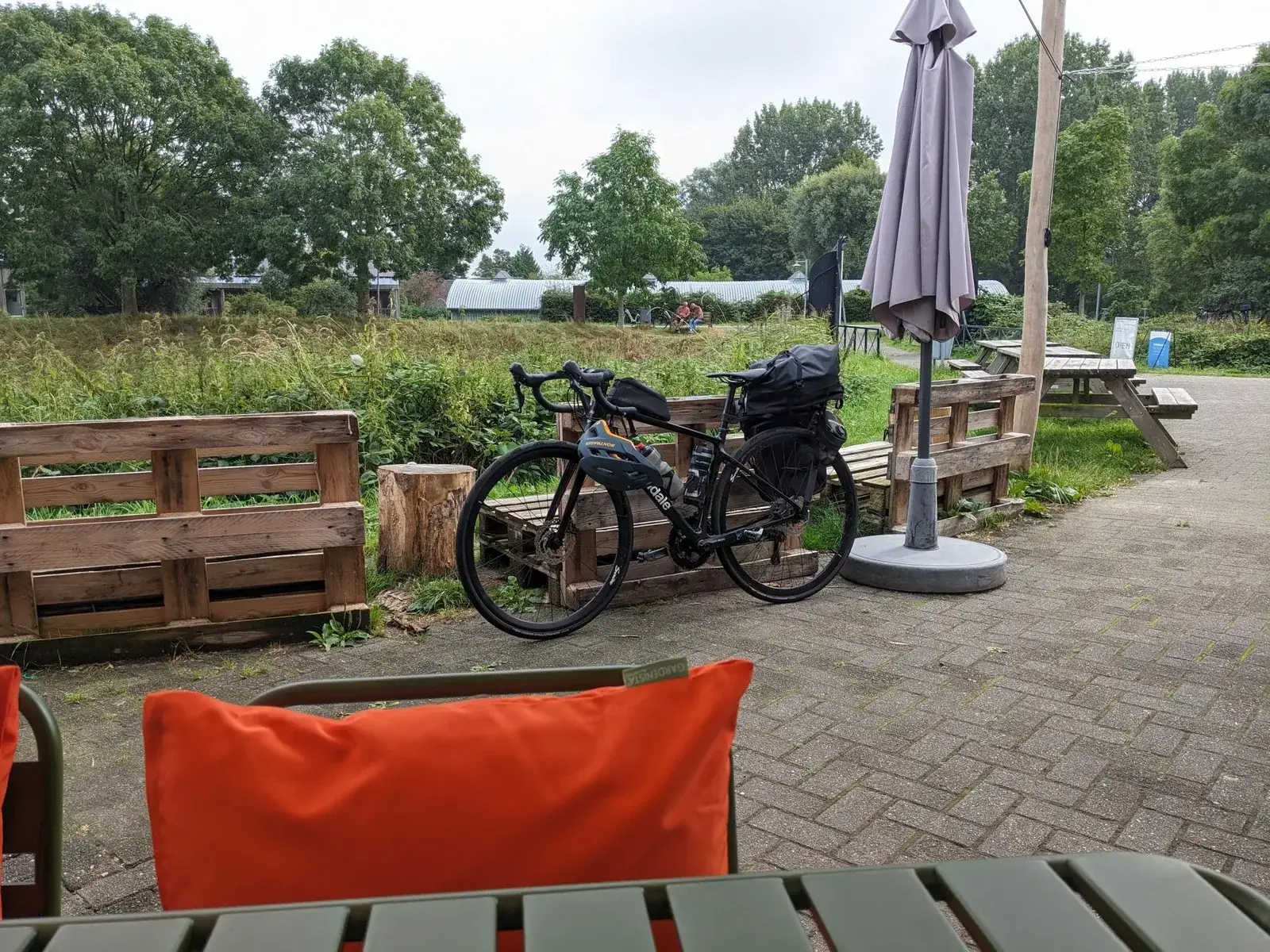 A loaded touring bicycle parked outside a rural café