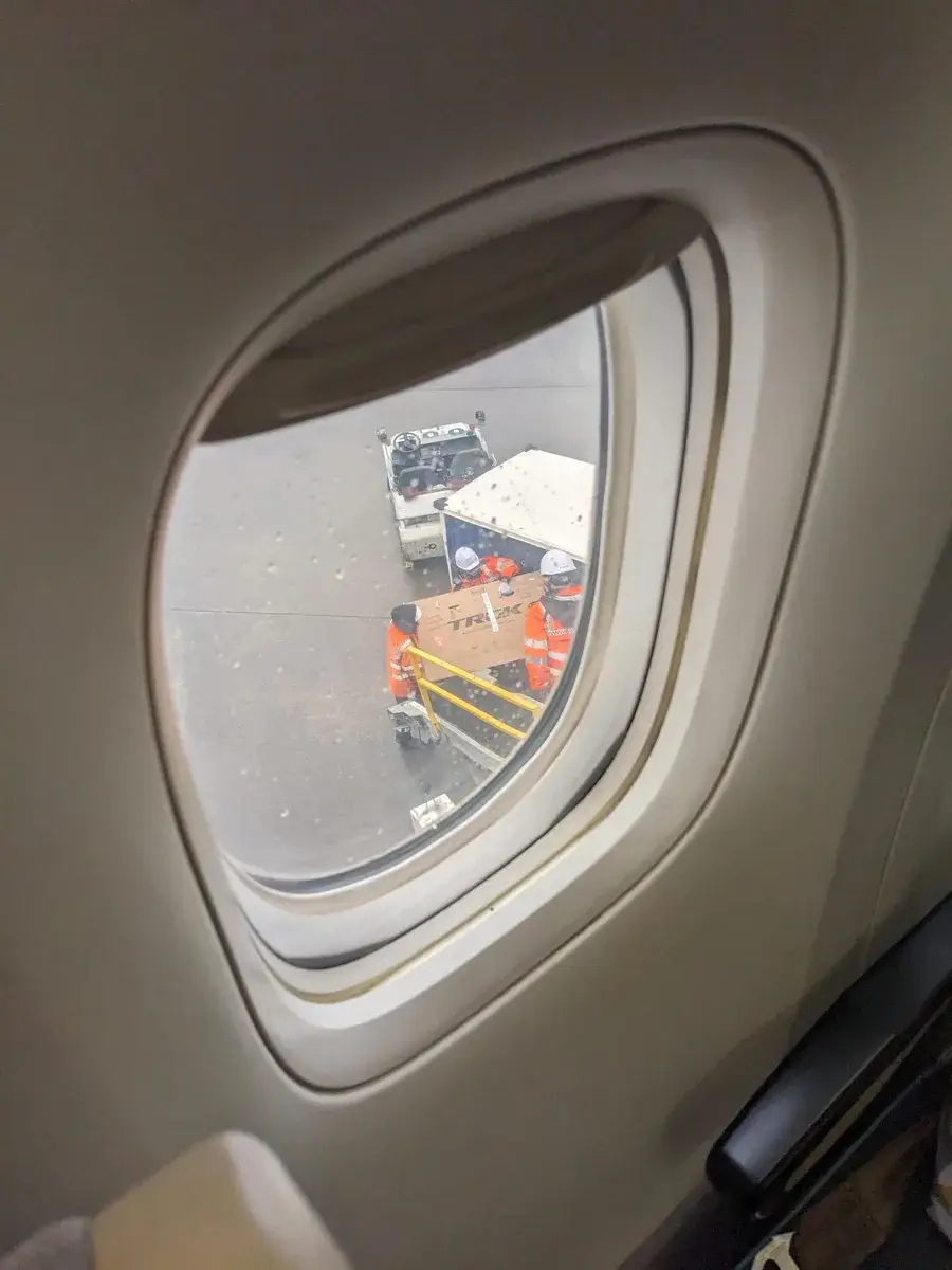 Airport ground vehicles viewed through an aeroplane window