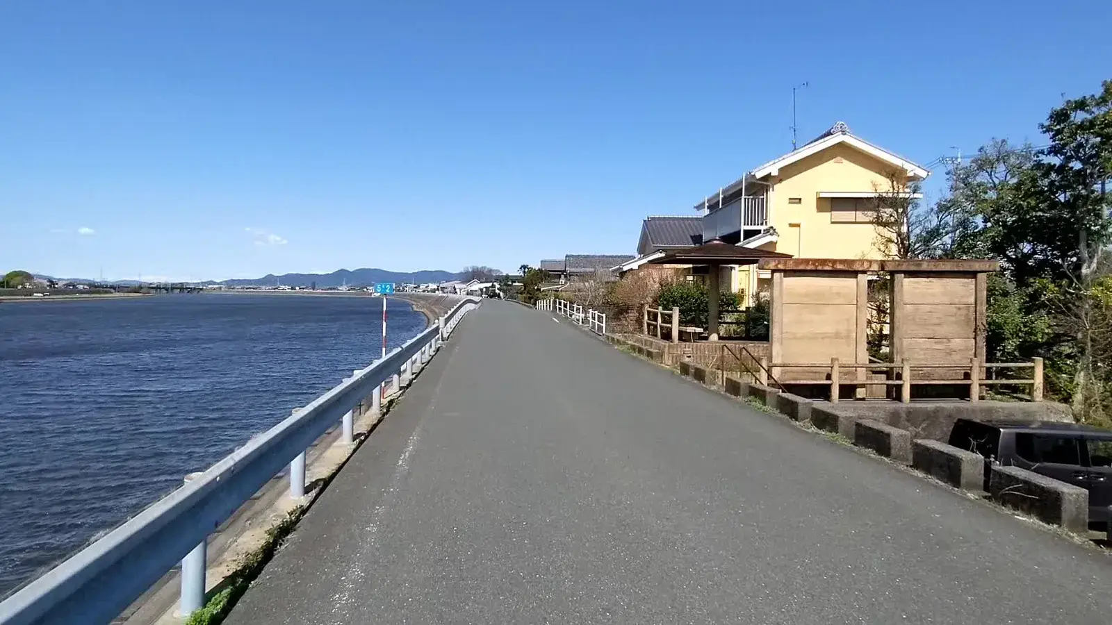 A coastal cycle path beside traditional houses