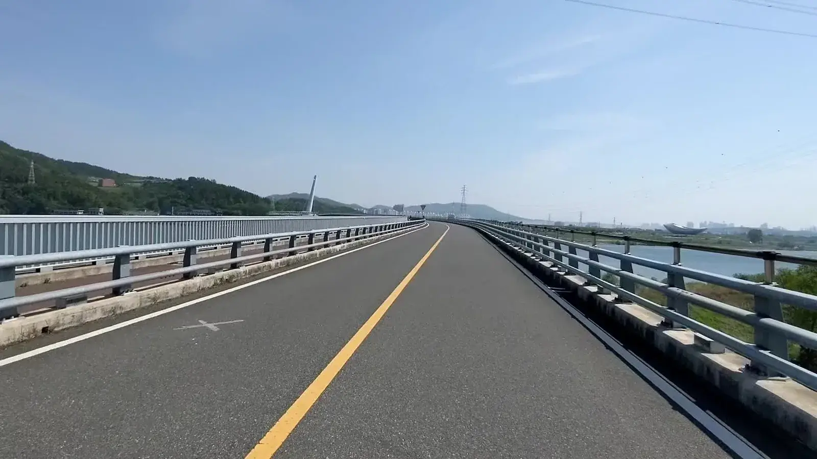 A long road bridge crossing open water