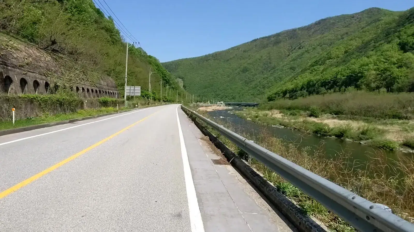A mountain road following a rocky river valley