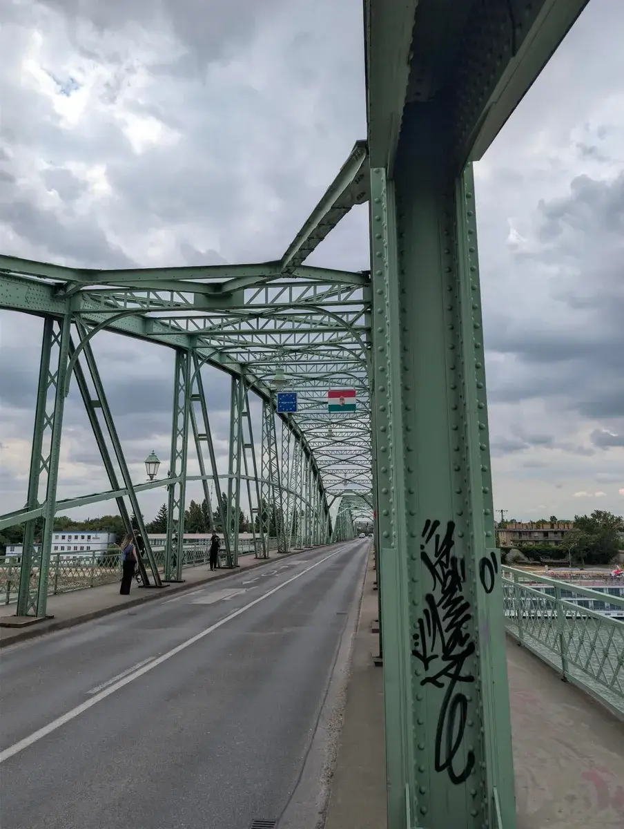 A cycle route crossing a green steel bridge