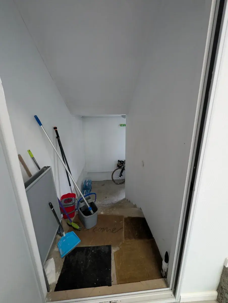 A bicycle stored in a white utility room