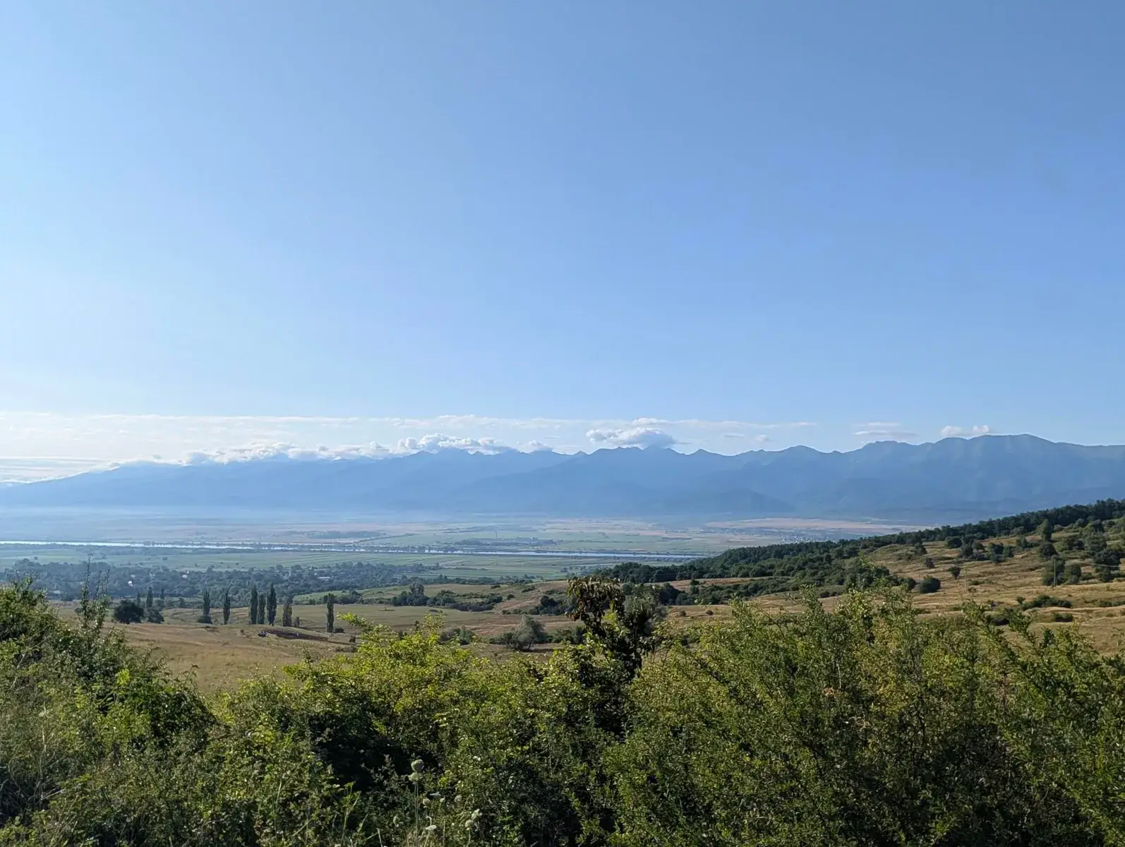 A distant alpine range viewed across a broad valley