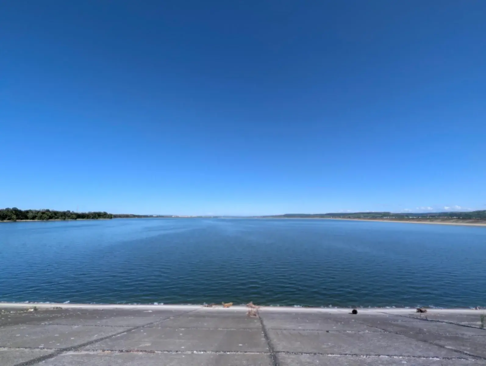 A deep blue lake beneath a cloudless sky