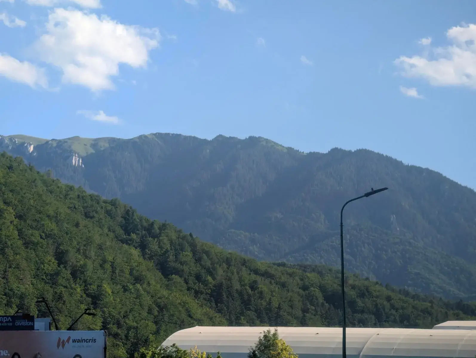 A jagged mountain ridge rising beyond forested slopes