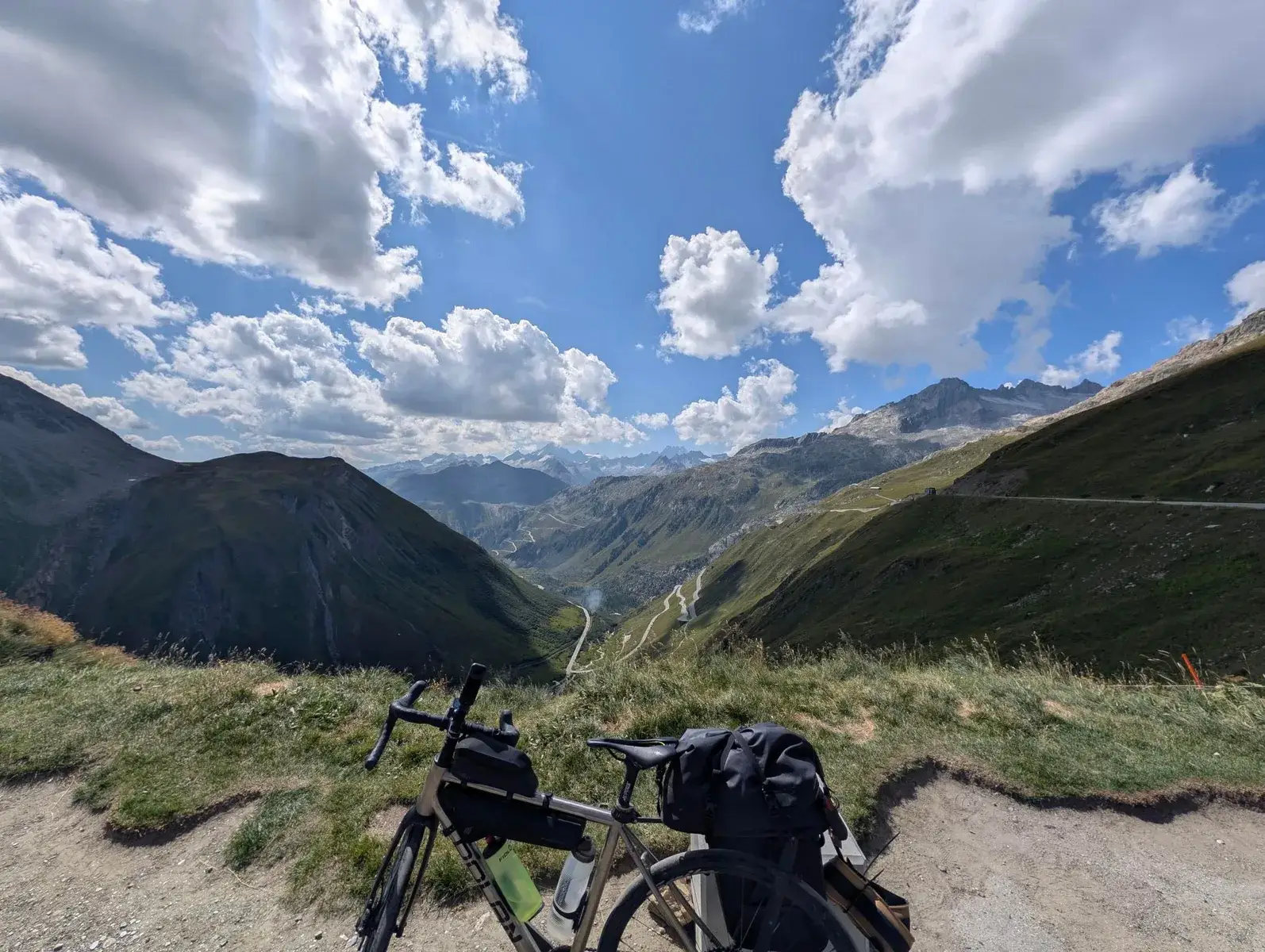 A loaded bicycle overlooking a high mountain pass