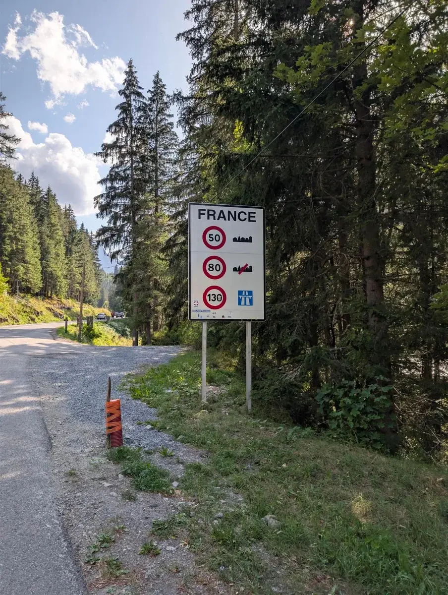 A France border sign on a forest road
