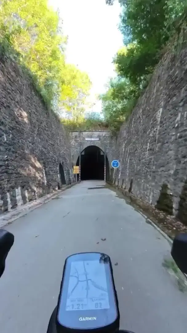 A cycle route entering a stone railway tunnel