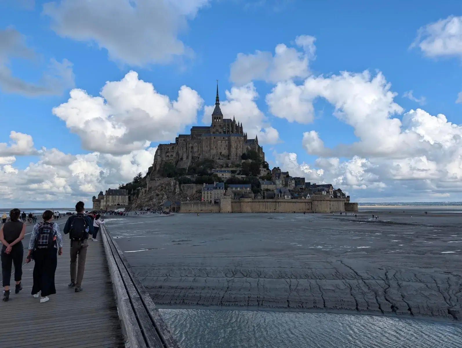 Mont Saint-Michel beneath towering white clouds