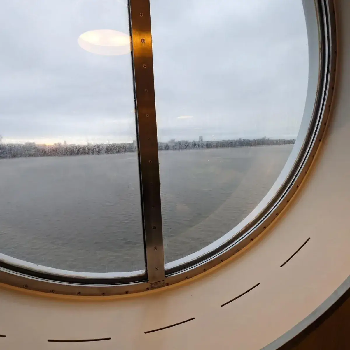 Grey sea viewed through a ferry window