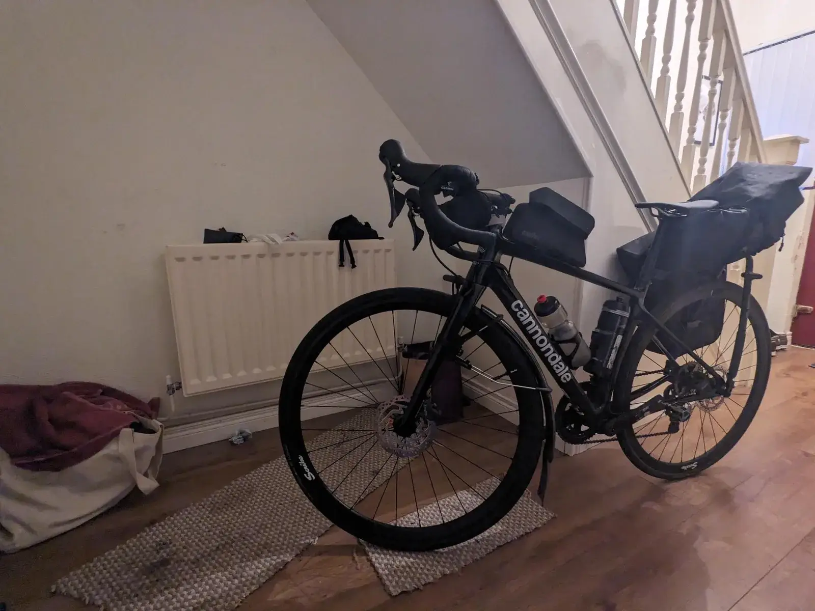 A loaded touring bicycle back indoors