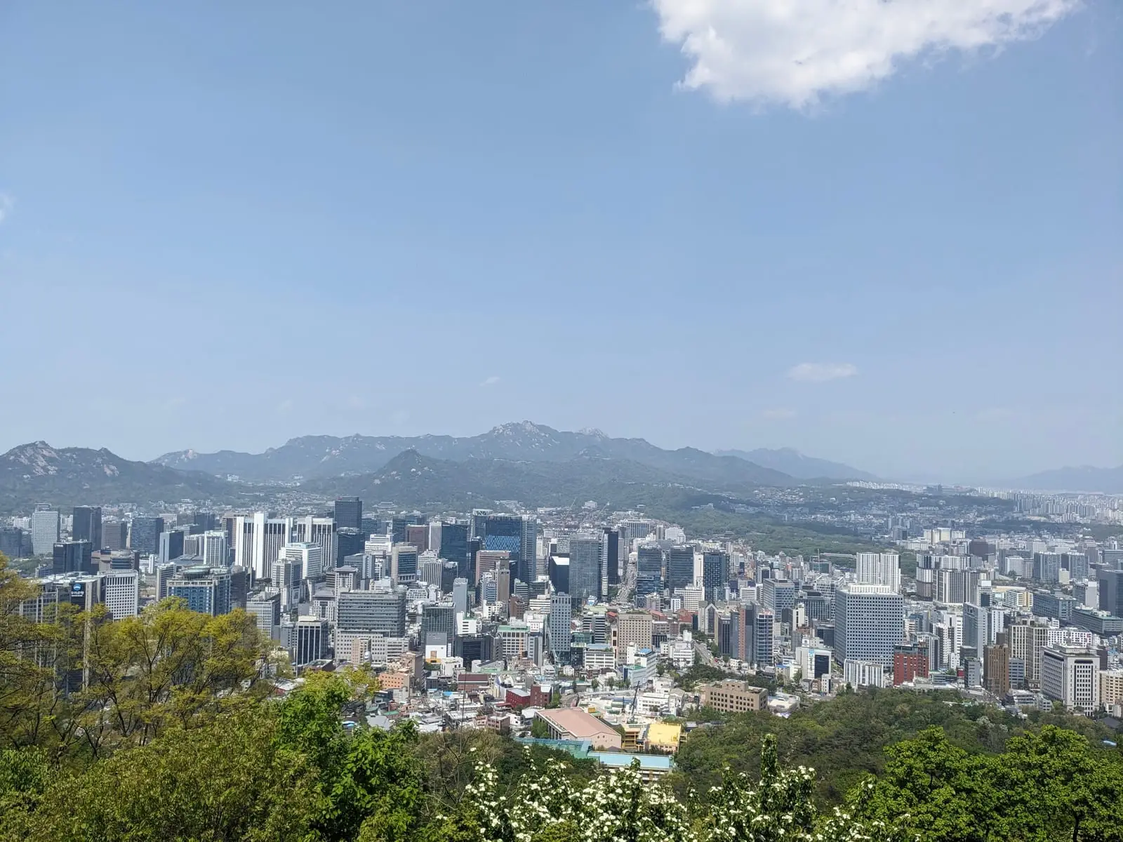 A high aerial view over dense central Seoul towers and streets