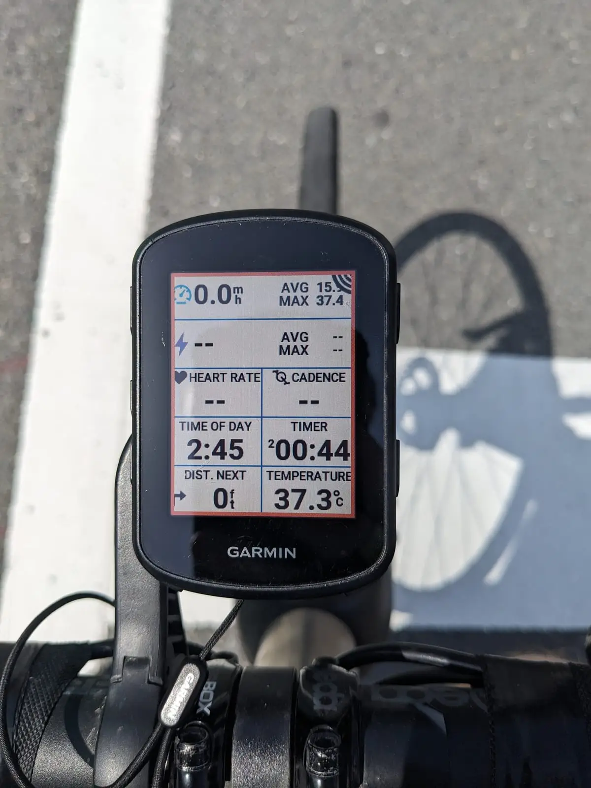A Garmin bike computer screen showing a temperature reading of 37.3 degrees alongside speed and heart rate fields