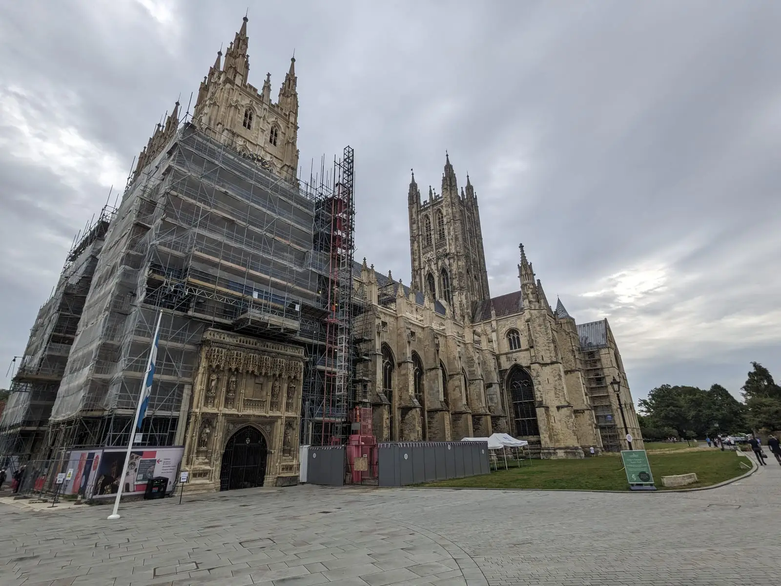 Canterbury Cathedral with its western towers wrapped in scaffolding under a grey sky