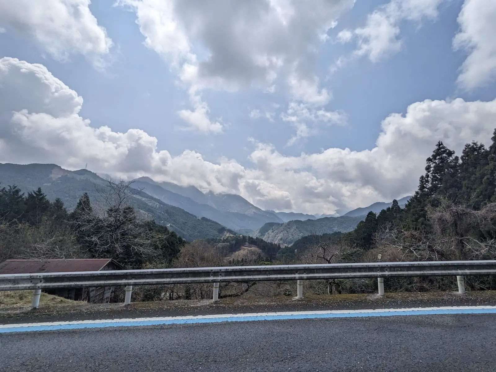 A clear view of layered mountain ridges and puffy clouds after the fog lifted