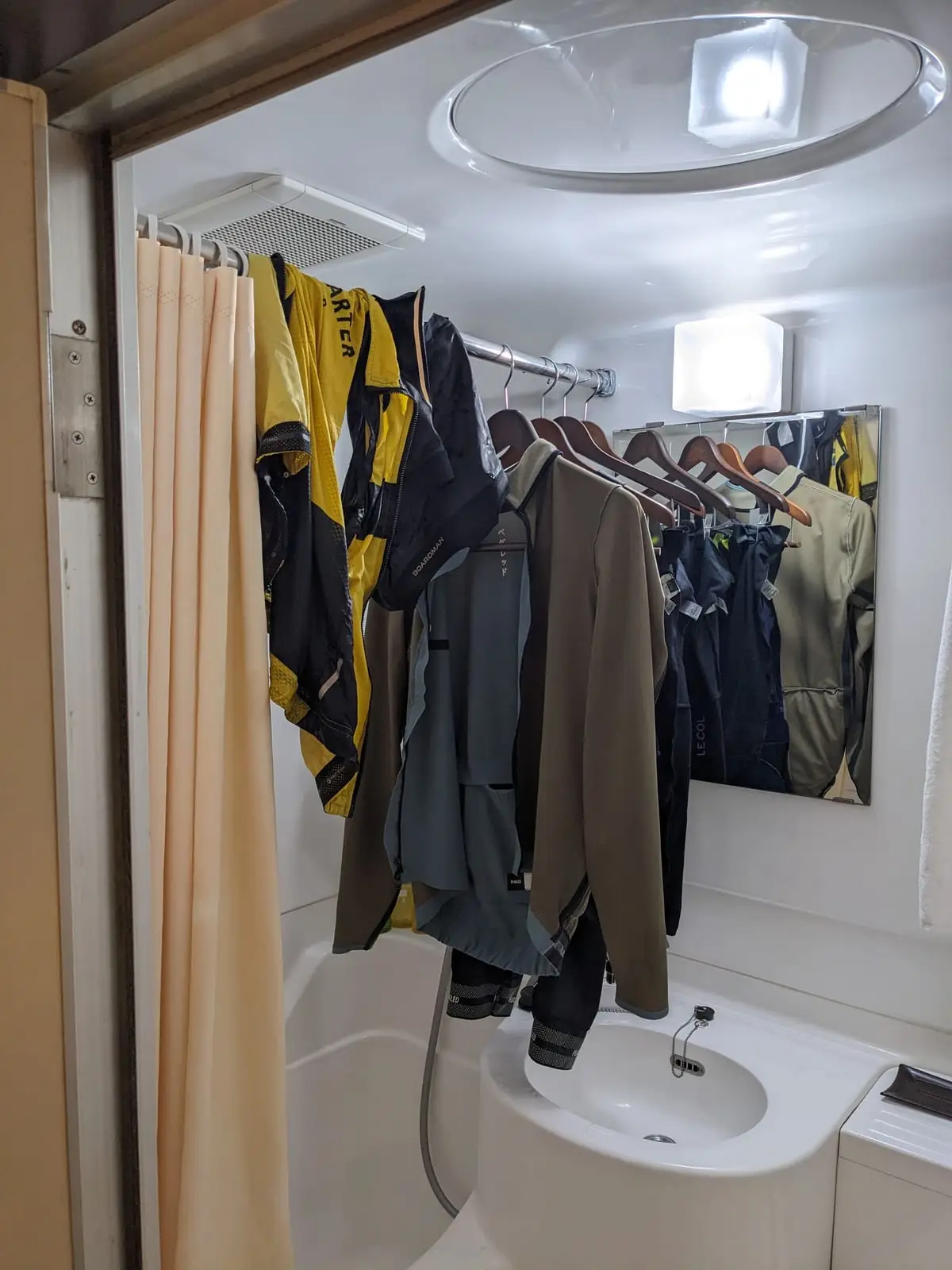 Cycling kit hung up to dry on hangers in a hotel room