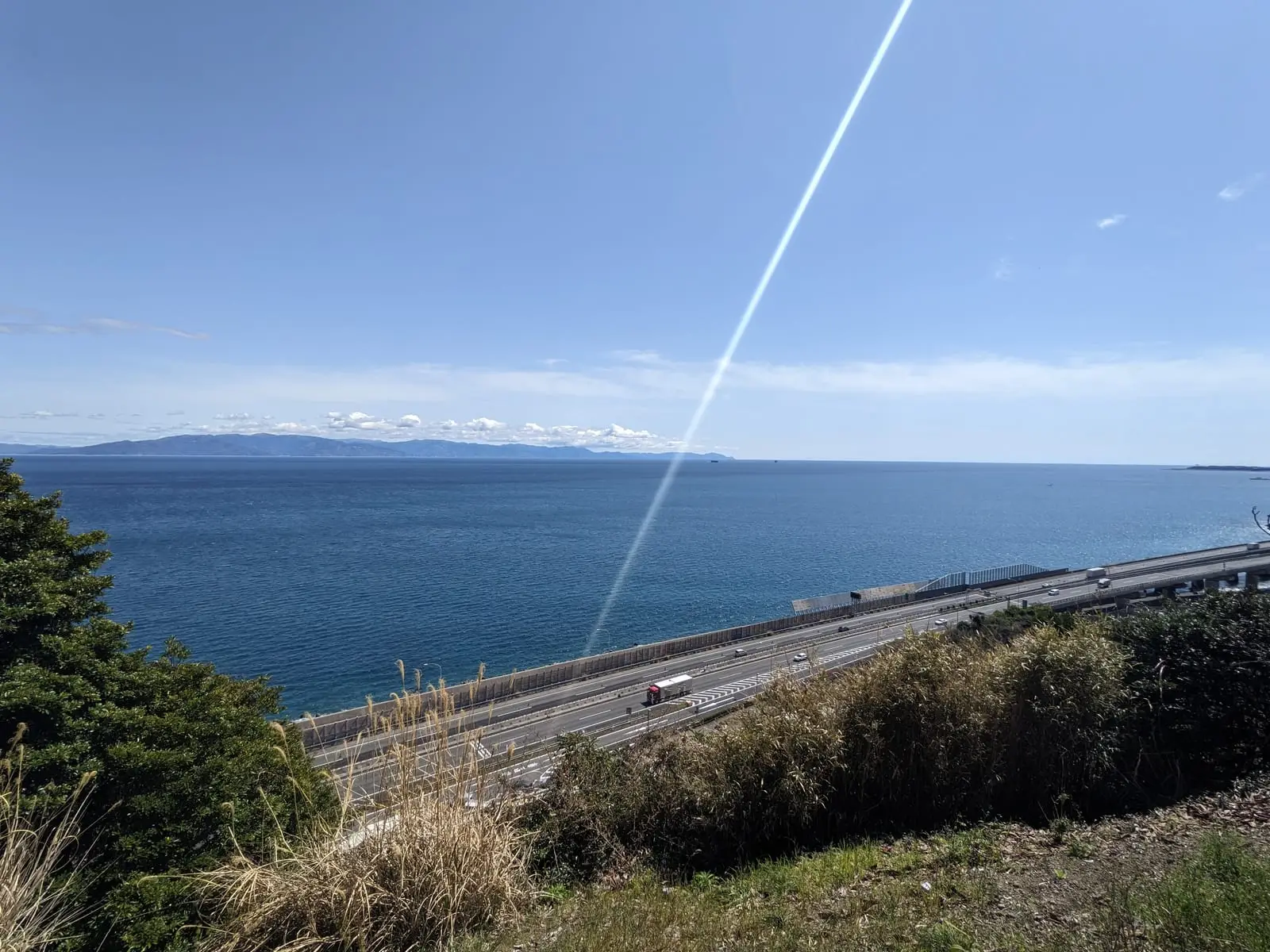 A quiet hill road with sea views running parallel to the main coast road below