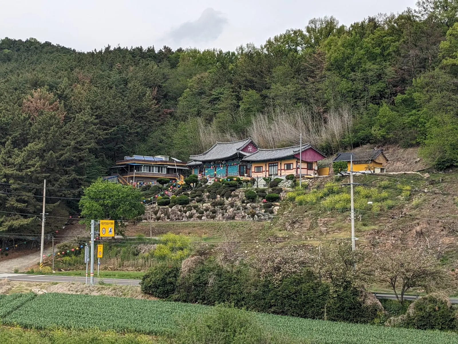 A hillside temple complex with terraced tiled roofs among trees