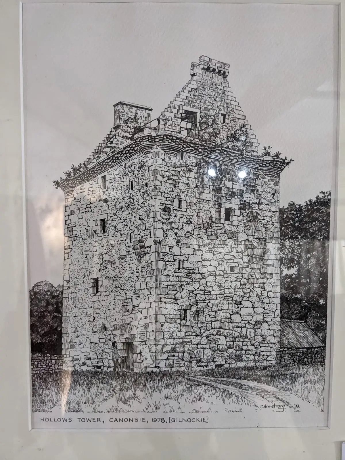 A framed historical drawing of Gilnockie Tower