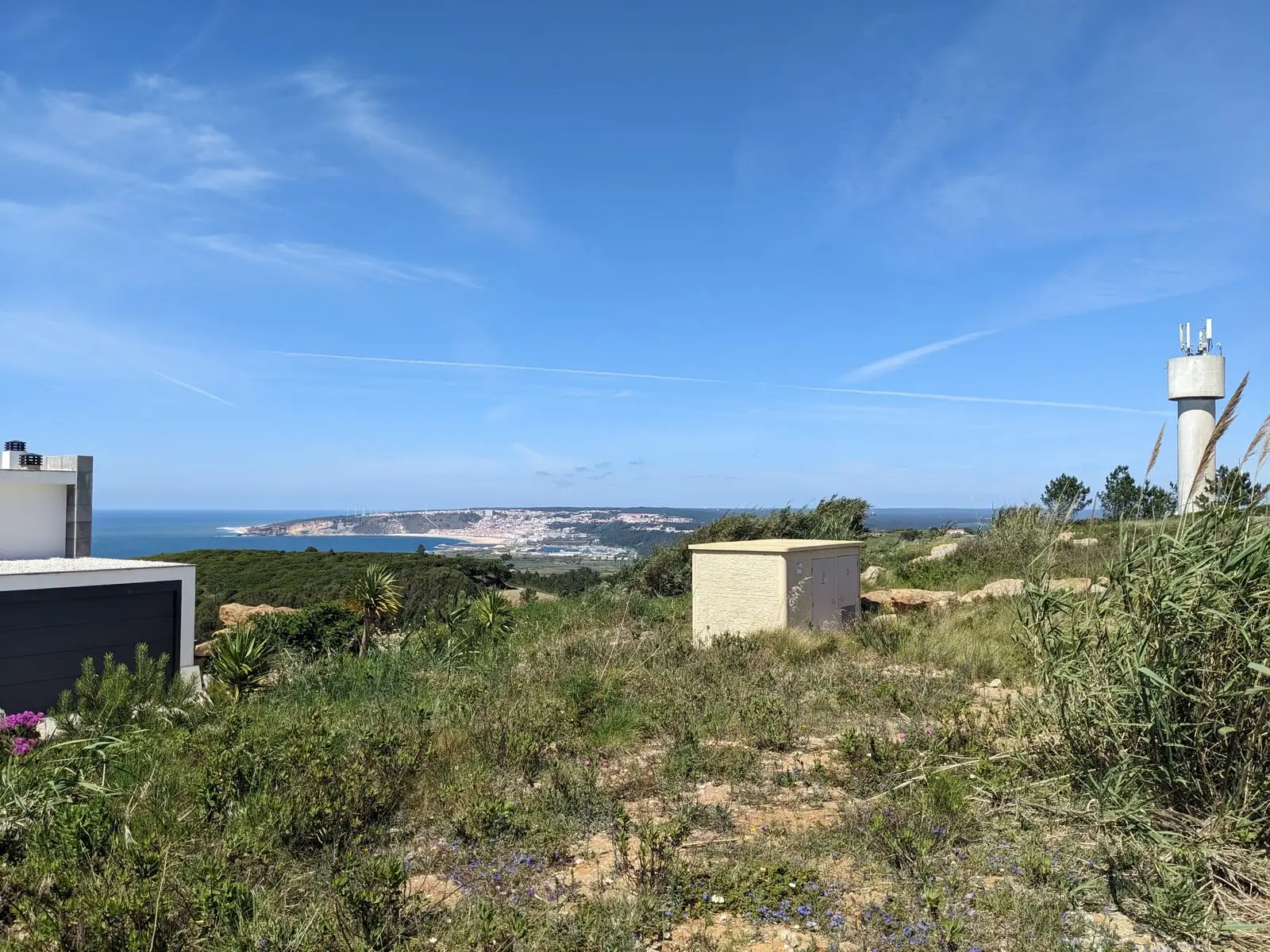 Nazaré seen in the distance across a green hillside