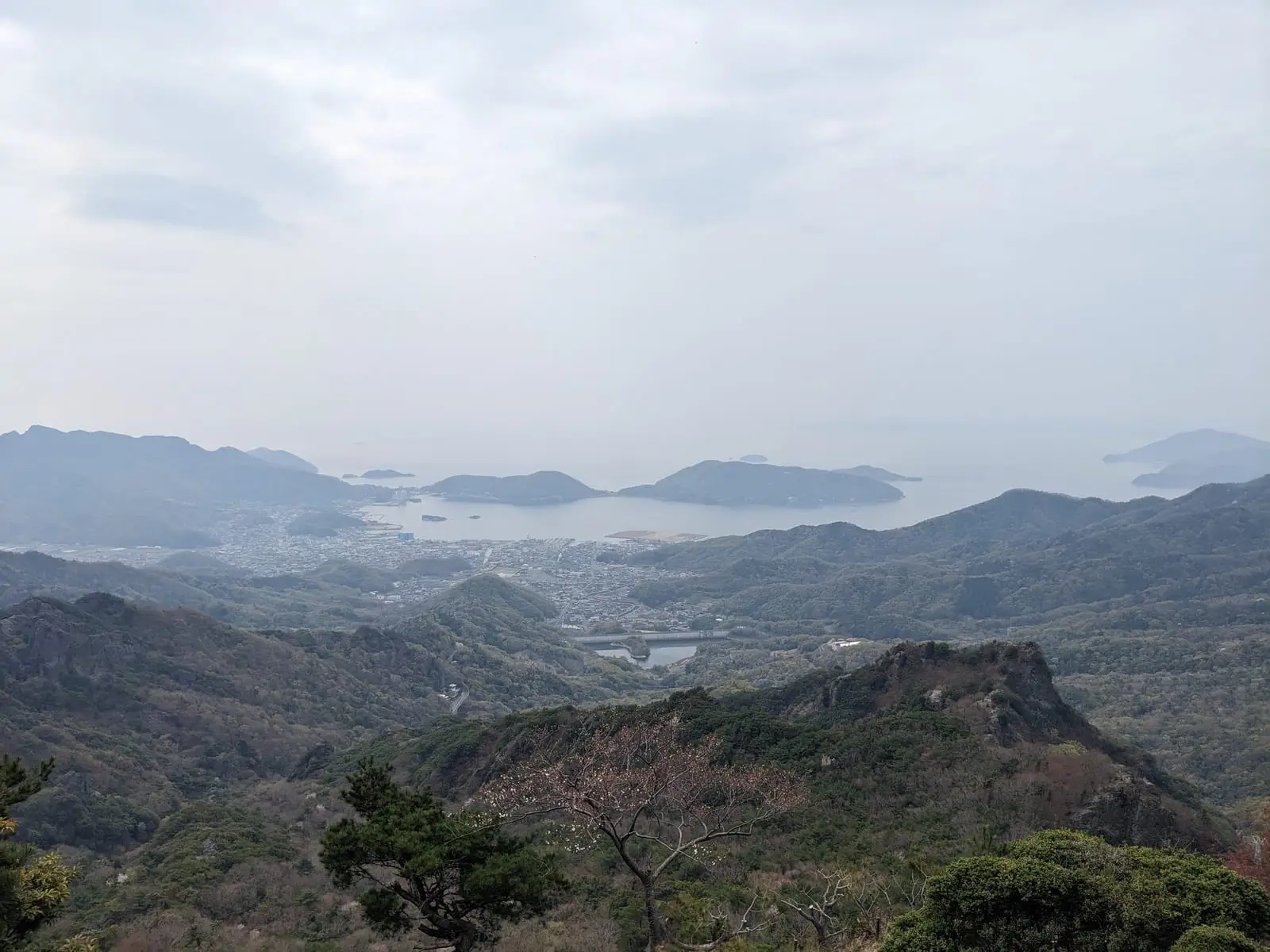 Misty, layered hills seen from the top of the island climb