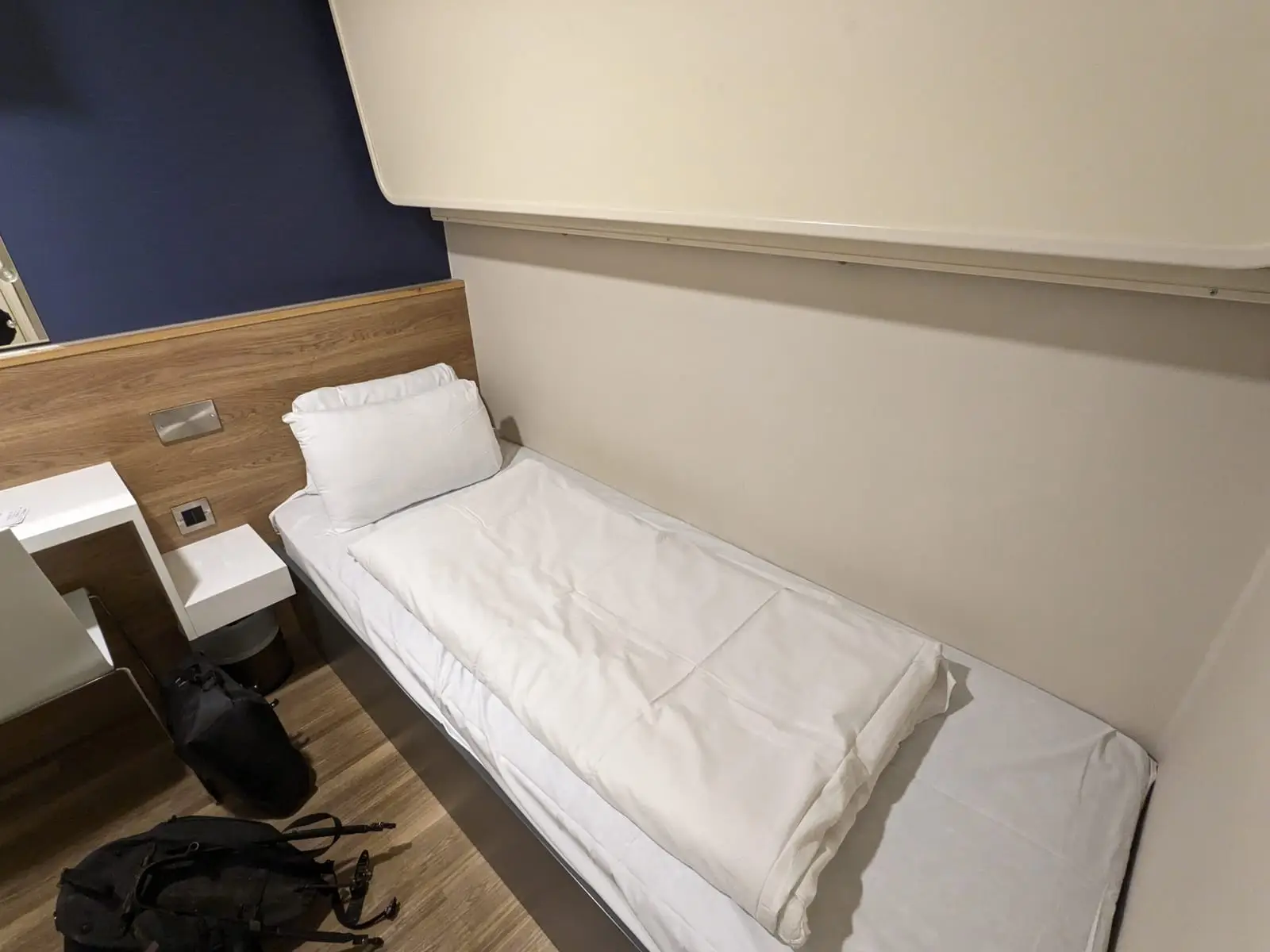 A single bed in a compact ferry cabin