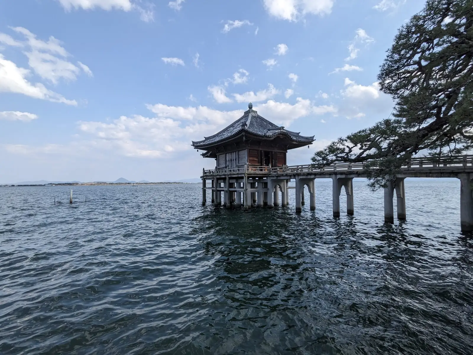 A wooden shrine building standing on stilts out in Lake Biwa, known locally as the Ukimido