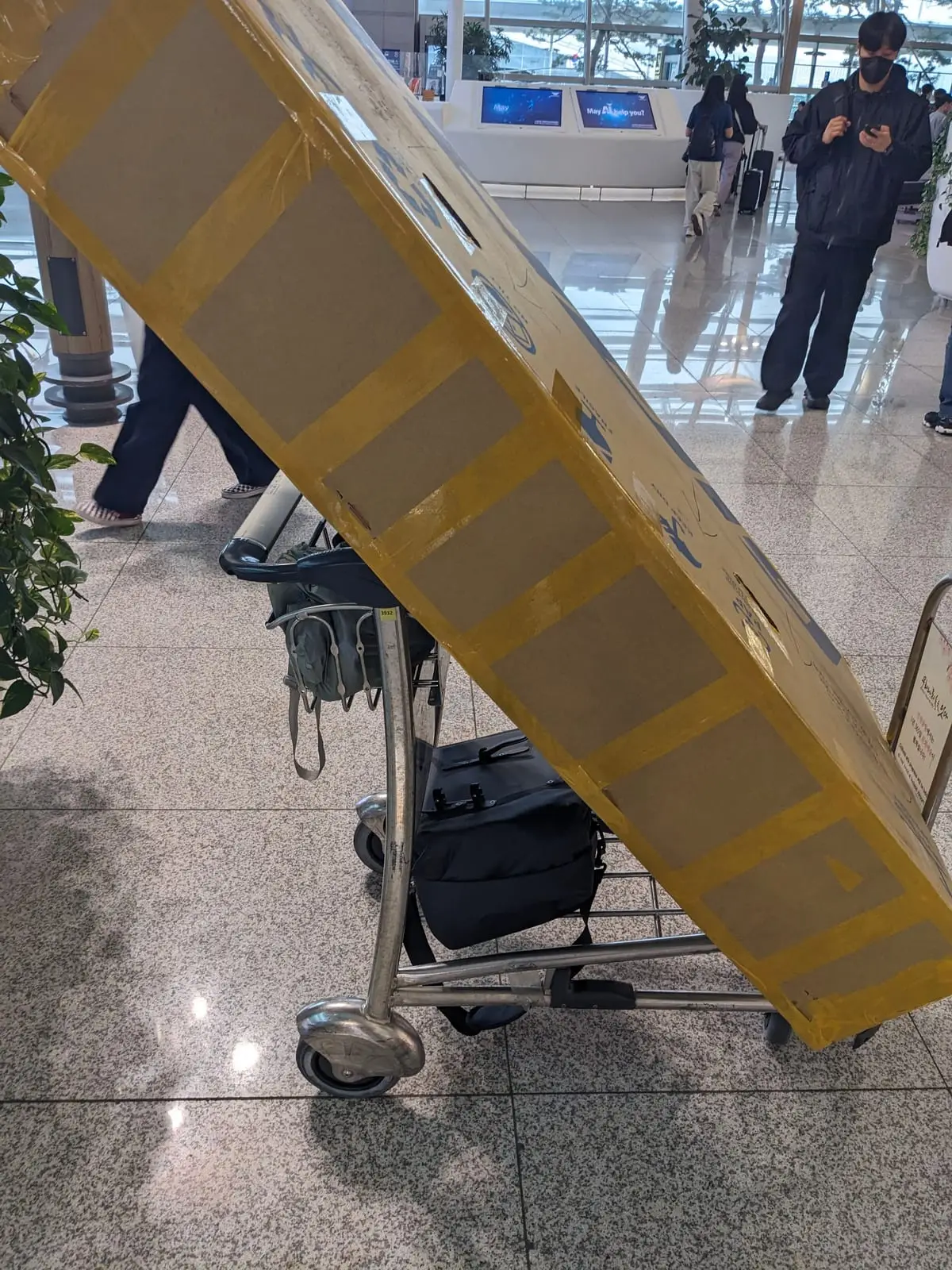 A close-up of the cardboard bike box being taped up before the flight home