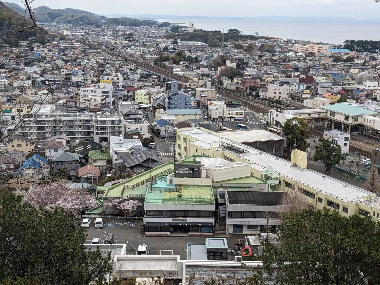 A view over a hillside town’s rooftops from partway up a flight of steps
