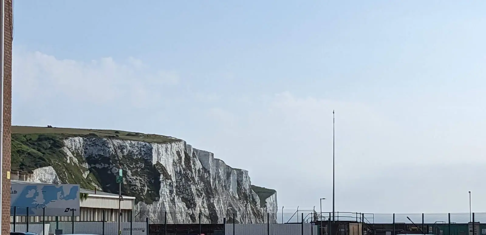 White chalk cliffs rising behind the ferry port at Dover