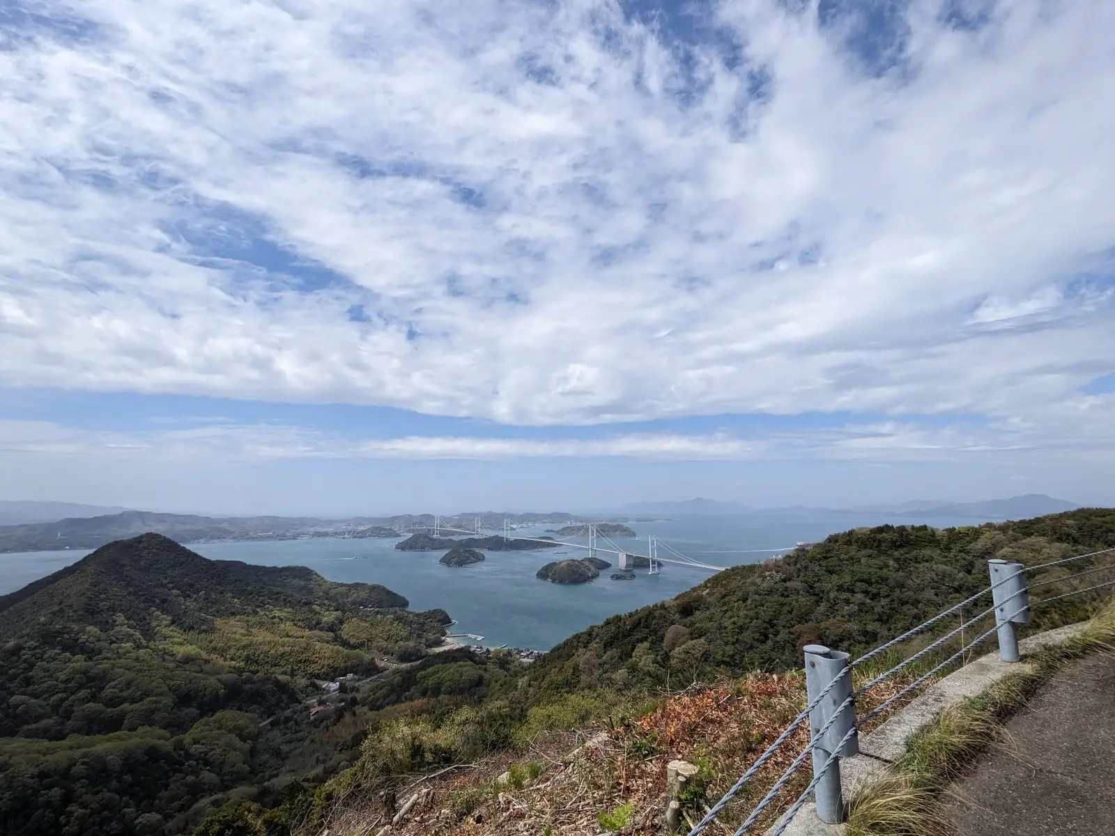 A wider hilltop view over the Seto Inland Sea’s islands under a bright sky